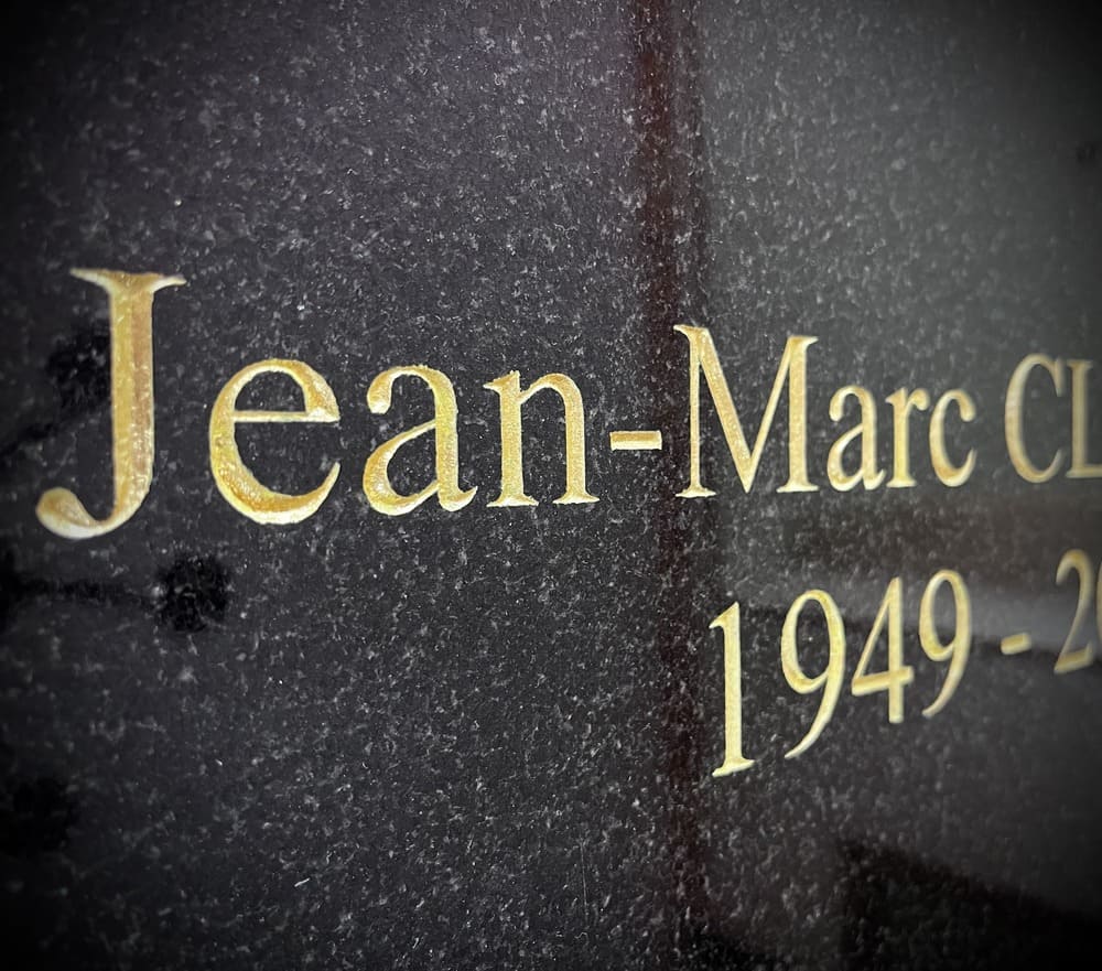 Plaque en granit noir, gravure et dorure.